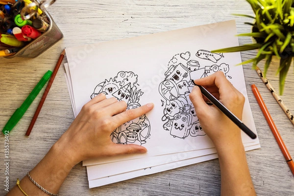 Fototapeta The process of drawing doodles with a pen. Antistress drawing, painting. Top view