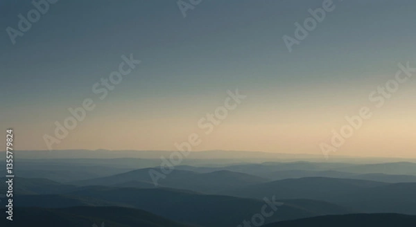 Fototapeta Aerial view of hazy mountain range at golden hour light