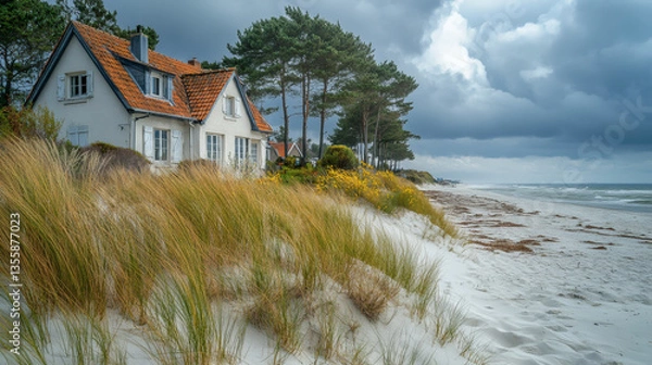 Fototapeta Coastal Cottage on Sandy Dune Overlooking the Sea with Overcast Sky and Evergreen Trees on a Sunny Day in France
