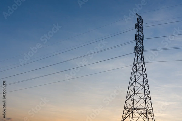 Fototapeta high voltage post.High-voltage tower sunset background.