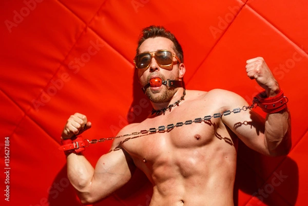 Obraz Male stripper on a red background.