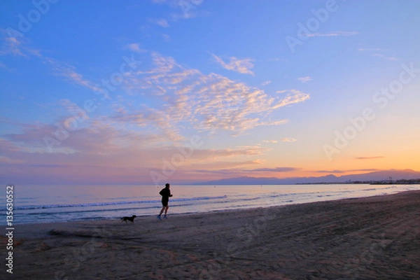 Obraz Evening jog along the beach.