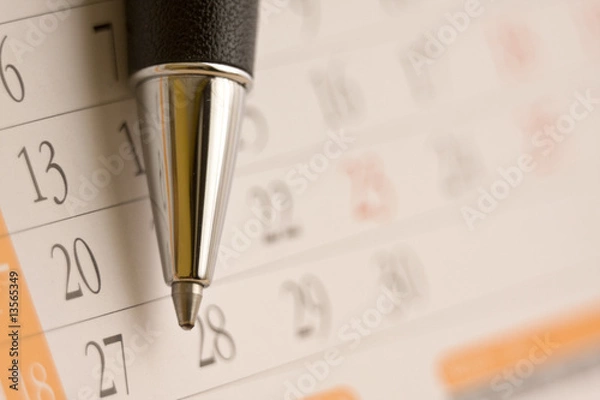 Fototapeta Planning future tasks on a calendar using a ballpoint pen.