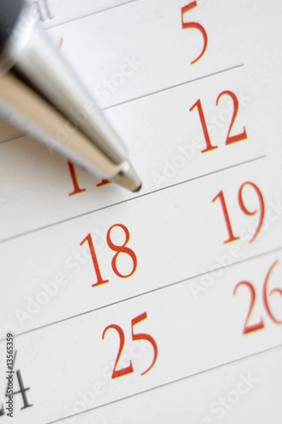 Fototapeta Planning future tasks on a calendar using a ballpoint pen.