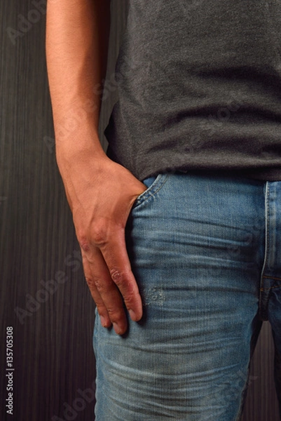 Obraz Close up of the right hand with big finger in a pocket of his bl