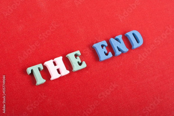 Fototapeta THE END word on red background composed from colorful abc alphabet block wooden letters, copy space for ad text. Learning english concept.
