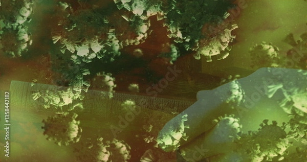 Obraz Coronavirus particles floating in greenish environment under microscope view