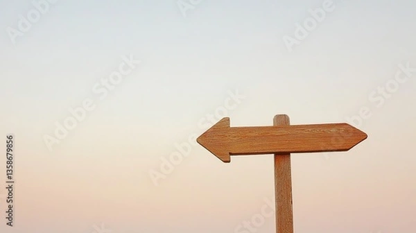 Fototapeta Wooden Arrow Signpost Against Gradient Sky, Symbolizing Direction and Simplicity
