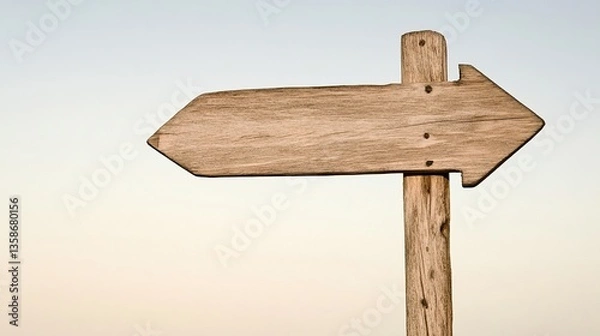 Fototapeta Wooden Arrow Signpost Against Gradient Sky, Symbolizing Direction and Simplicity
