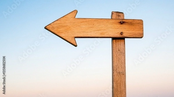 Fototapeta Wooden Arrow Signpost Against Gradient Sky, Symbolizing Direction and Simplicity
