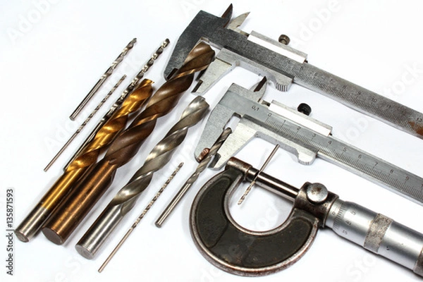 Obraz Drill bits and micrometer screw caliper on white background