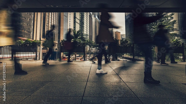 Fototapeta Commuters in Wan Chai using a Pedestrian crossing in the rush hour over Gloucester Rd, Hong Kong