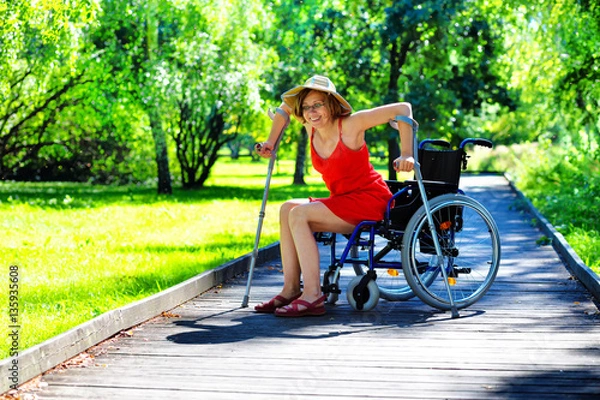 Obraz woman gets up from a wheelchair