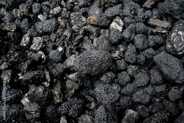 Fototapeta Pile of black coal stones with roughness and bulging on the outside, intended as fuel for domestic or industrial use, extracted from the mining basins of Asturias