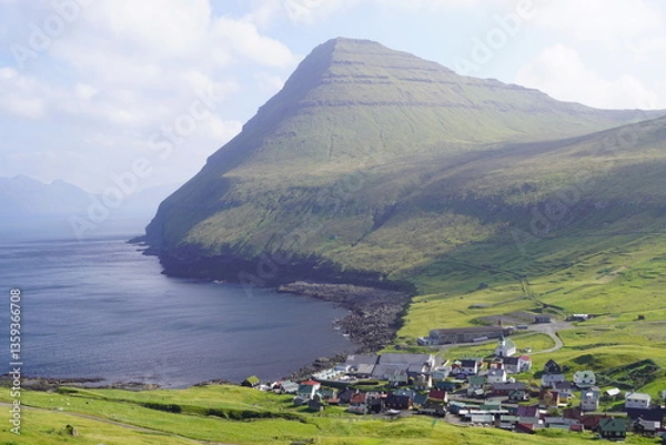 Obraz The steep cliffs and beautiful green valley of Gjogv by the blue Atlantic Ocean in Faroe Islands