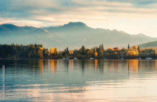 Fototapeta Sunrise over mountain range and autumn forest on Lake Wanaka