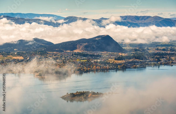 Fototapeta Scenic foggy mountain from summit of Roys Peak with Lake Wanaka in the morning at New Zealand