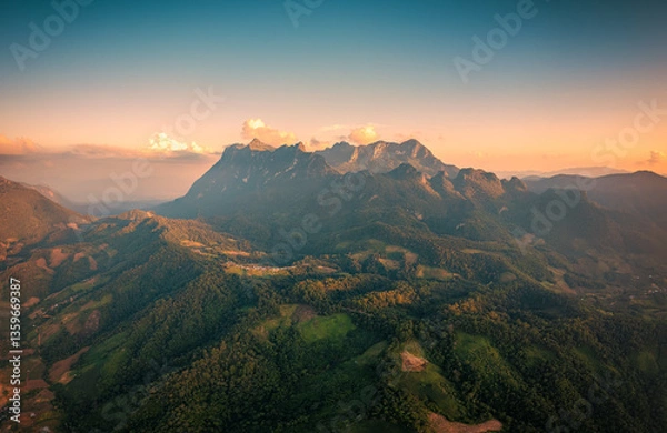 Fototapeta Doi Luang Chiang Dao limestone mountain wildlife sanctuary over local village on mountain in the evening