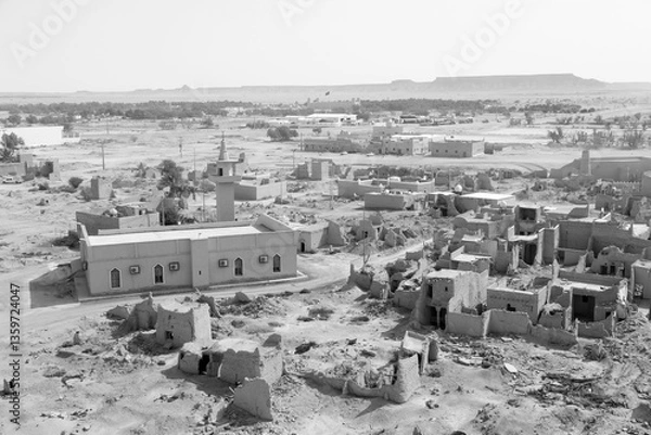 Fototapeta View of the small village Raghba with the abandoned mud houses in the middle of the desert in Saudi Arabia