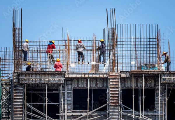 Fototapeta Construction workers steel binding wire