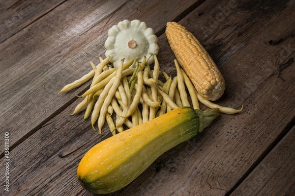 Fototapeta vegetables  green beans, corn, zucchini, squash on old wooden background in rustic style