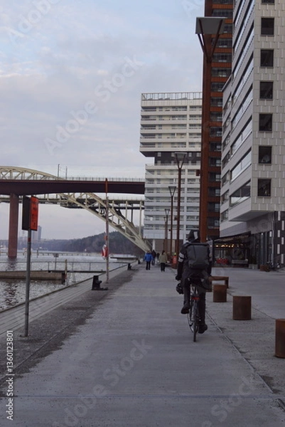 Obraz A biker around modern urban architecture