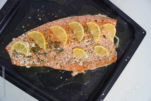 Obraz A whole red salmon filet with lemon and herbs