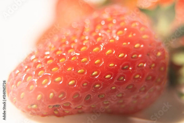 Fototapeta Close-up texture detail of a strawberry, See the seeds attached to the outer surface, red, beautiful.