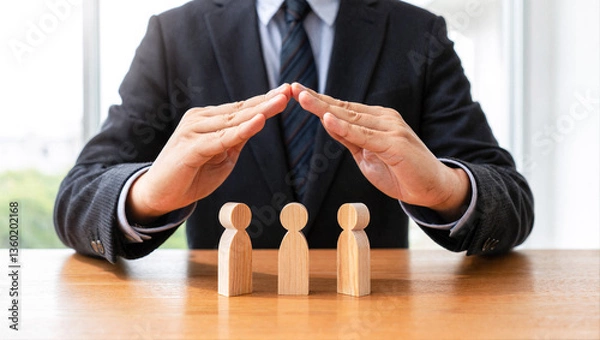 Obraz Man's hands protect family figures. Concept of family care, support, community, and social responsibility offering shelter and defense.