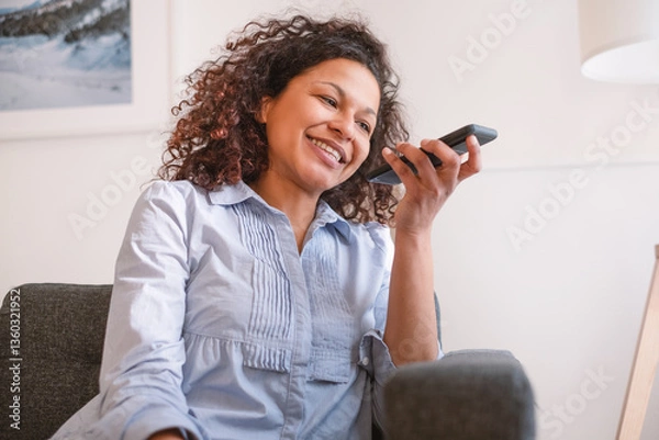 Obraz Portrait of black woman talking to phone virtual assistant