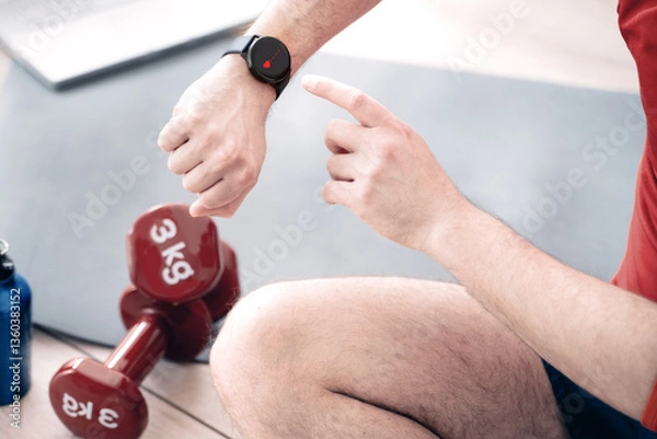 Fototapeta Close up of athlete using smart watch cardio app