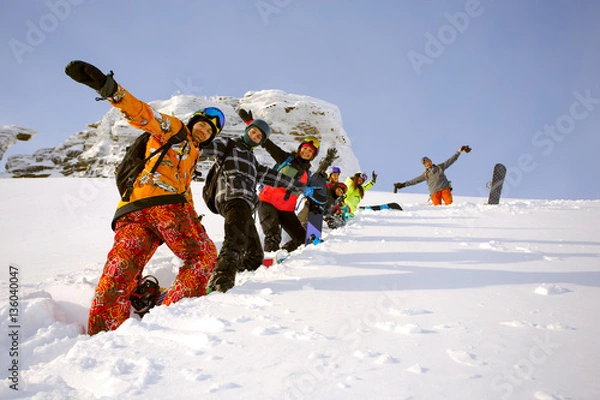 Fototapeta Group of friends snowboarders having fun on the top of mountain
