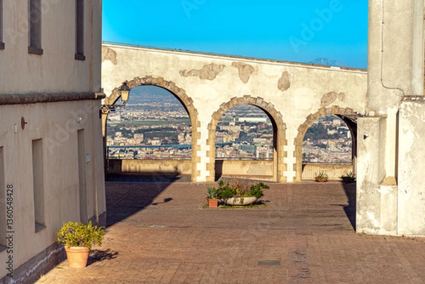 Fototapeta Bridge ramp with walkway over the main entrance to the drill ground of the fortress Castel Sant'Elmo in Naples, the fortress that towers high on the Vomero hill, above the city of Naples.
