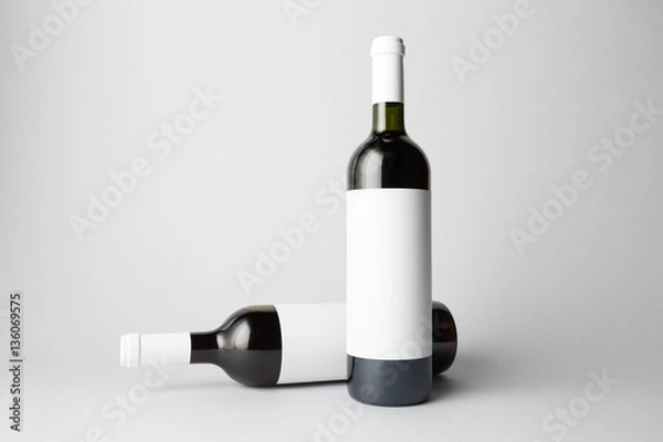 Fototapeta Two wine bottles are standing on gray background