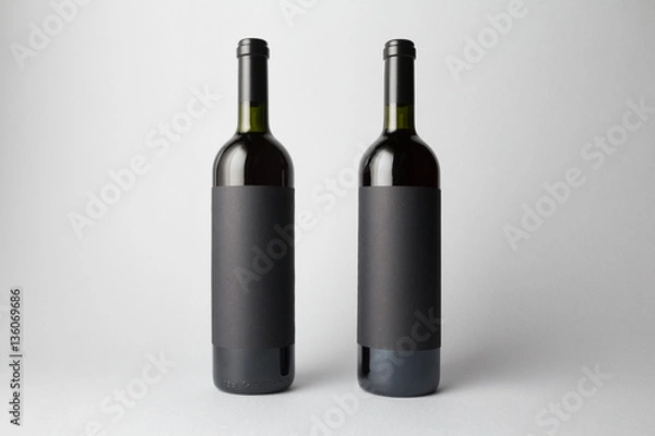Obraz Two wine bottles are standing on gray background