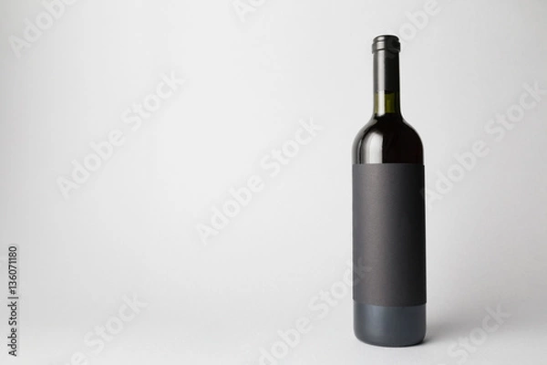 Fototapeta Wine Bottle is standing on gray background