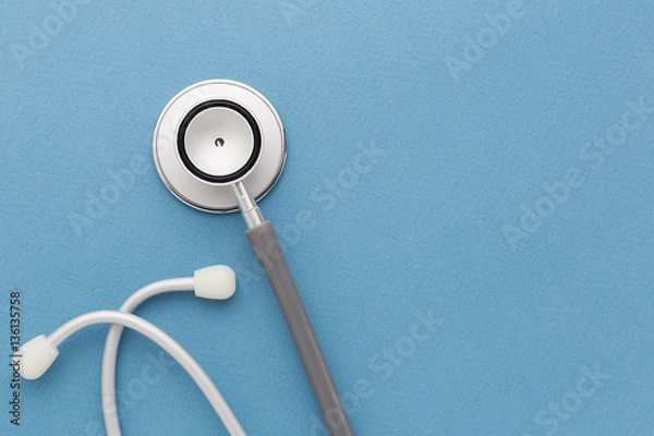 Fototapeta Stethoscope on blue background
