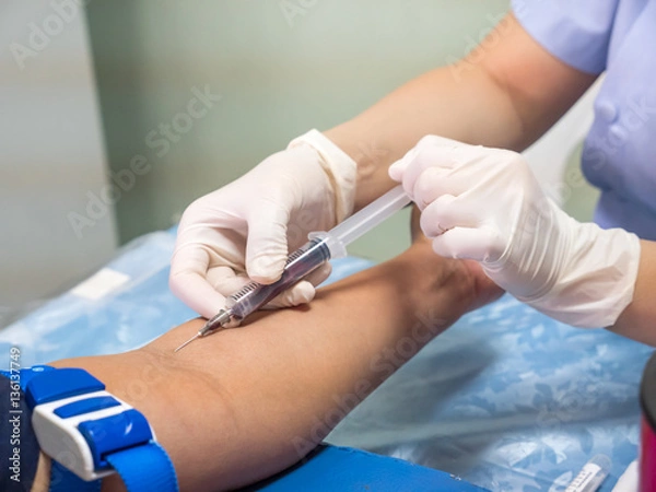 Fototapeta nurse with syringe is taking blood for test at the laboratory