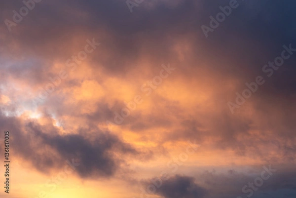 Fototapeta Cloudscape at golden hour with warm tones.