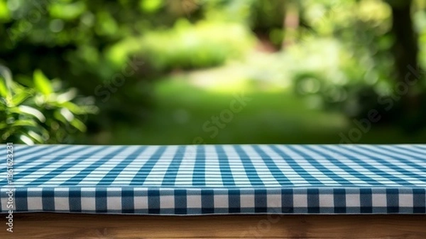 Obraz Dynamic depth-of-field composition featuring gingham table linen on soft-focus meadow background, ready-to-use mockup for beverage packaging design, outdoor wedding stationery, and gourmet catering ad