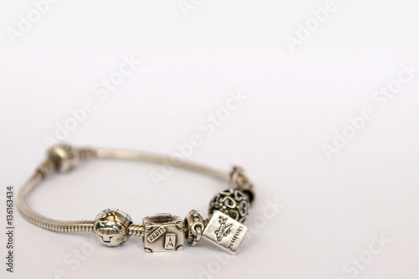 Obraz Silver beads and charms isolated