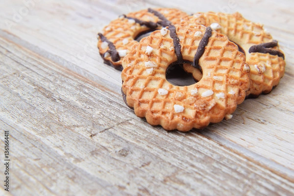 Fototapeta Cookies crispy pastry glazed with chocolate and sugar on the table