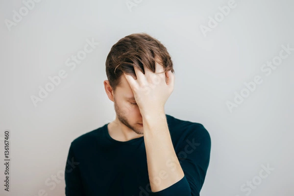 Fototapeta Portrait of a caucasian man hiding his face