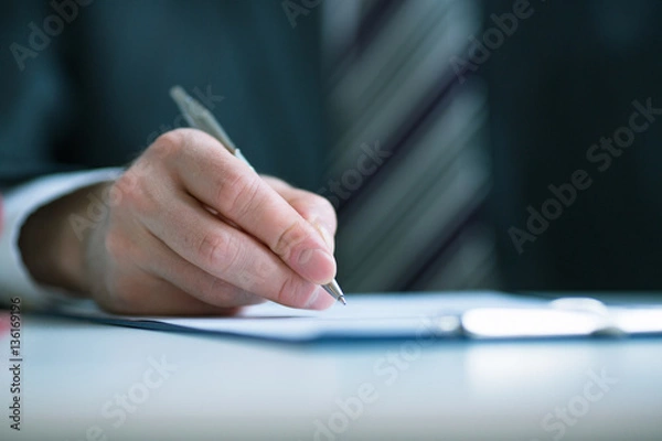 Fototapeta Business concept: businessman signs a contract