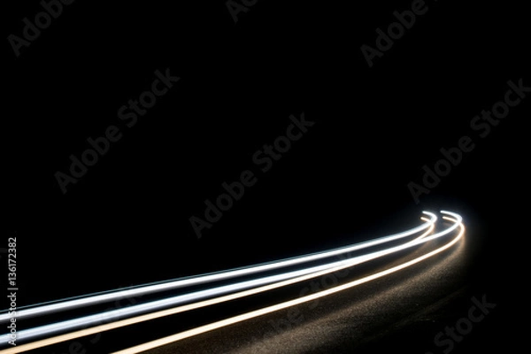 Fototapeta Abstract white light trails in the dark that can be used as background or texture