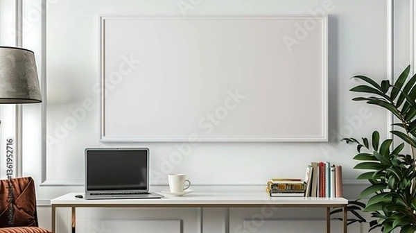 Fototapeta A white rectangular frame hanging above a console table in a hallway, surrounded by a coffee cup, a laptop, HD 8K mockup wallpaper Photographic Image