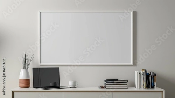 Fototapeta A white rectangular frame hanging above a hallway console with a cup, a laptop, and a few books. HD 8K mockup wallpaper Photographic Image