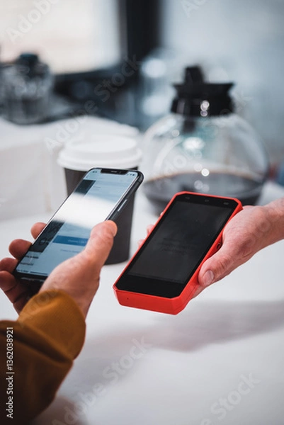 Fototapeta Close-up: a customer makes a purchase in a coffee shop, pays with a QR code. Scans the QR code with a smartphone in the bank's application.