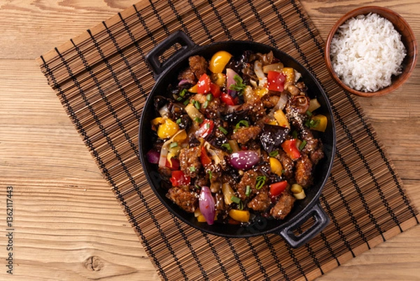 Obraz Traditional Asian sweet and sour pork with paprika and sesame. Prepared in a wok.