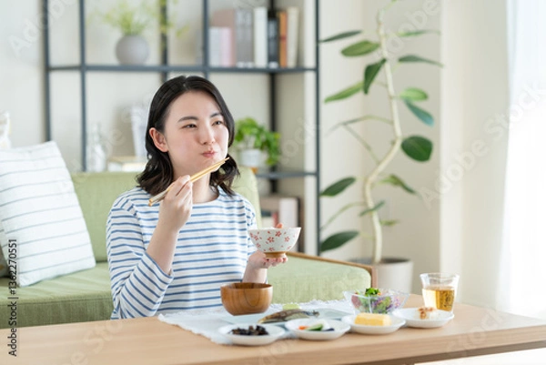Fototapeta 朝食を食べる若い女性